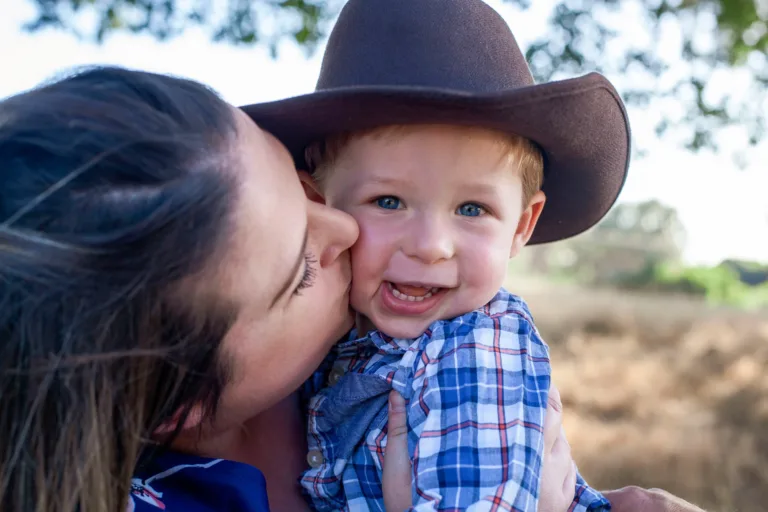 Portrait of mom giving kisses to her son in Northern California.