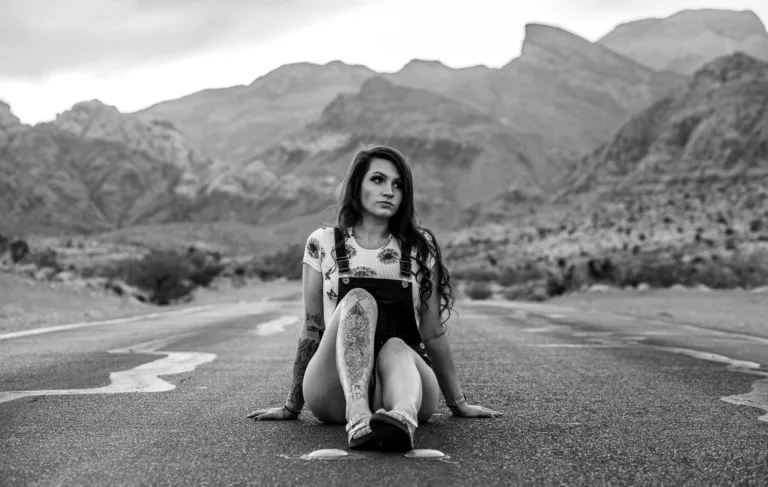 Female in the road posing for a portrait at Red Rock Canyon in Las Vegas.