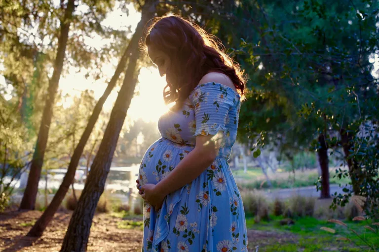 Mother to be at sunset posing for a maternity portrait at a park in Southern California.