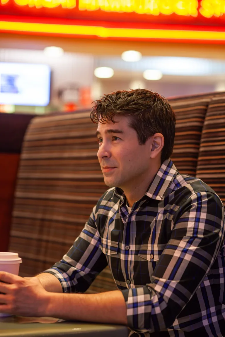 Casual portrait of a man having a warm cup of coffee at the Red Rock Casino food court in Las Vegas.