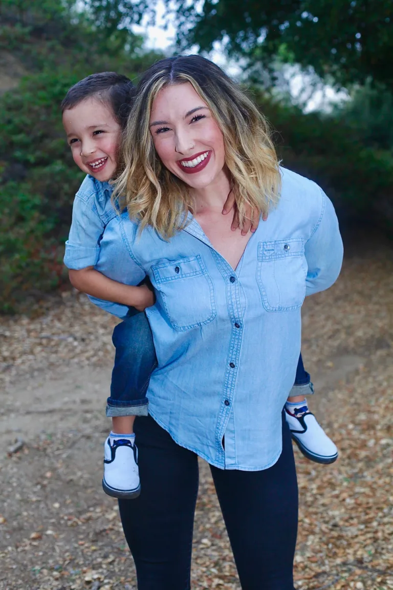 Portrait of big sister giving her little brother a piggy back ride in Wildomar, California.