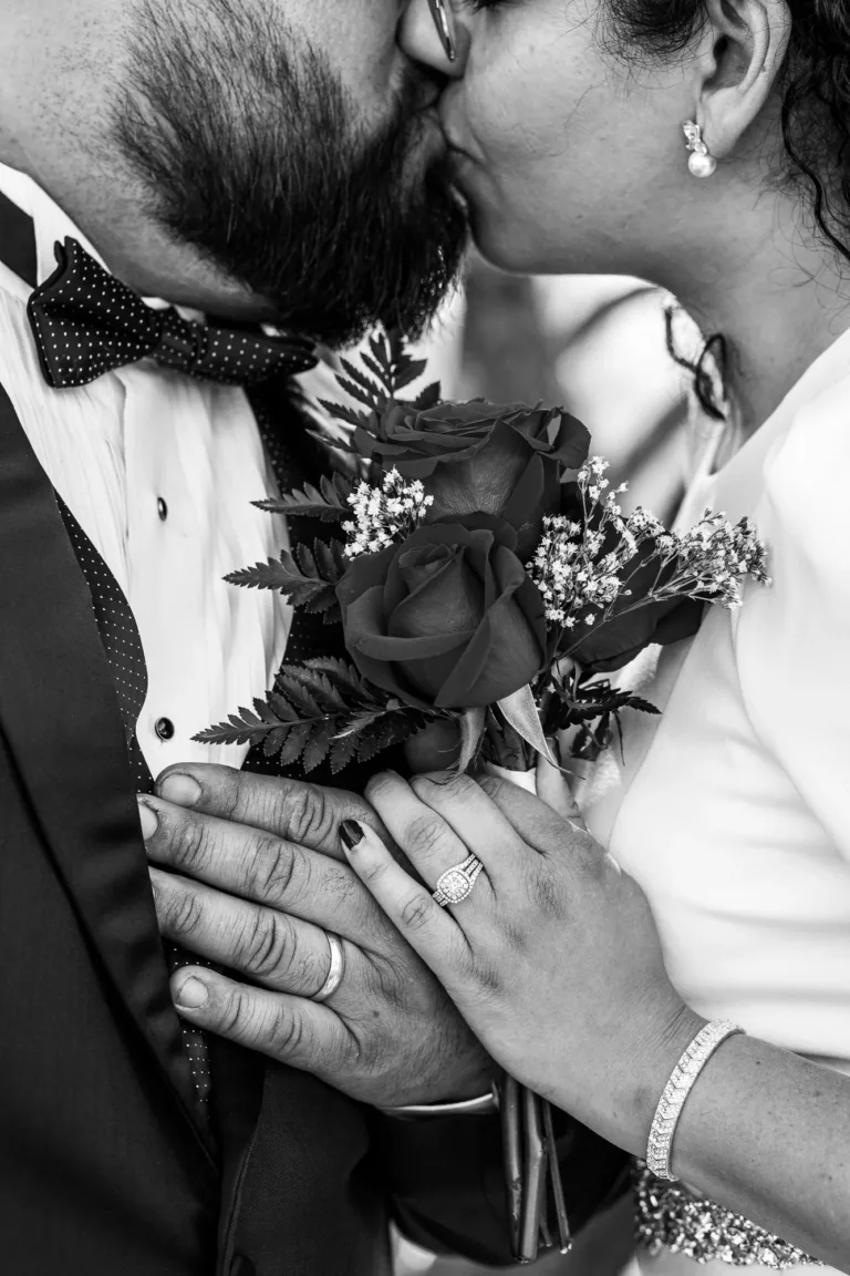 Close up portrait of bride and groom with their wedding rings.