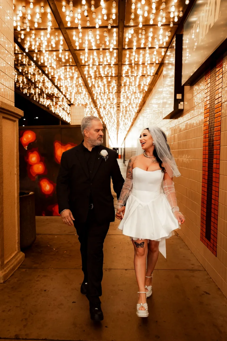 Newlywed couple posing on Fremont Street in Downtown Las Vegas
