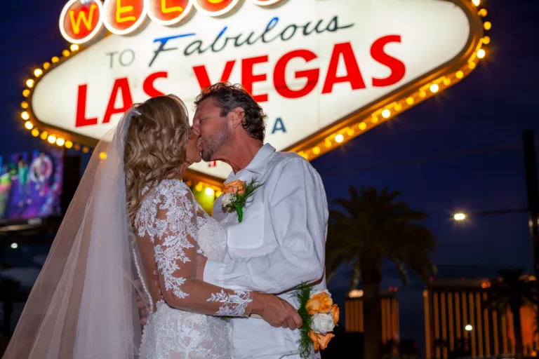 Newlywed couple sharing a kiss at the Las Vegas Sign