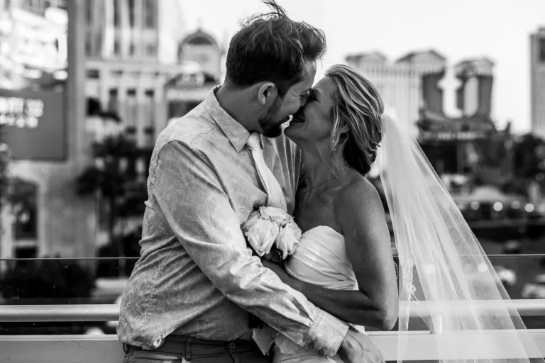 Newlywed couple sharing a kiss on the Las Vegas Strip after their wedding