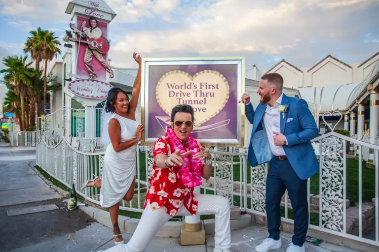 Newlywed couple posing with Elvis after their ceremony at the Little White Wedding Chapel in Las Vegas