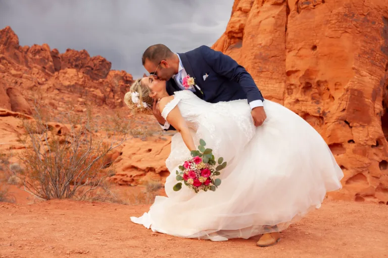 Newlywed couple sharing a dip at Valley of Fire State Park in Nevada