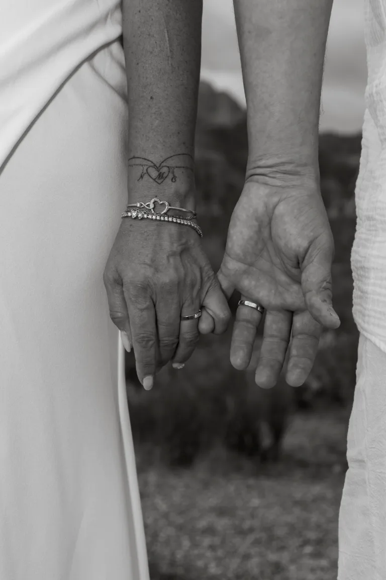 Newlywed couple showing off their wedding rings at Red Rock Canyon in Las Vegas