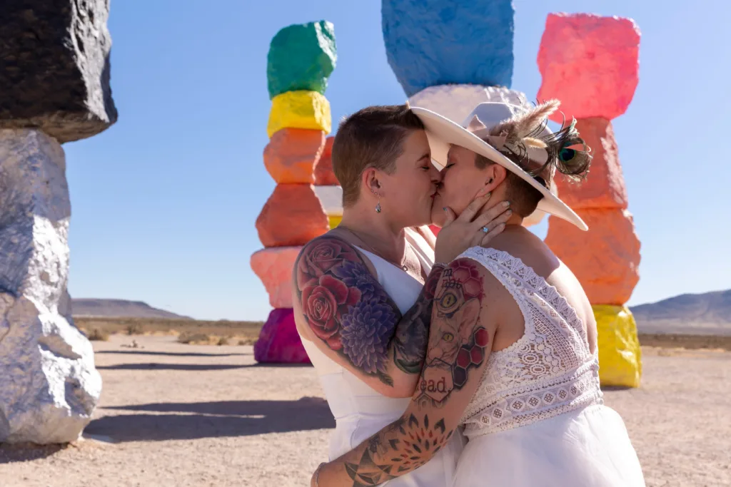 Lesbian couple celebrating their elopement with a kiss at 7 Magic Mountains in Las Vegas